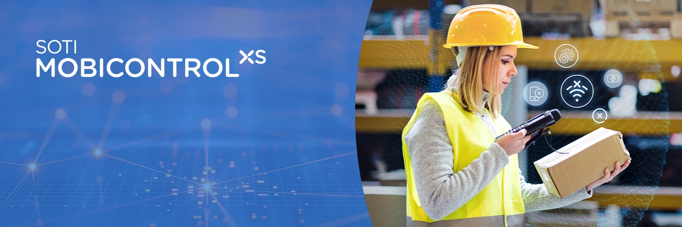SOTI MobiControl | Lady in a vest and a hard hat scans a box in a warehouse